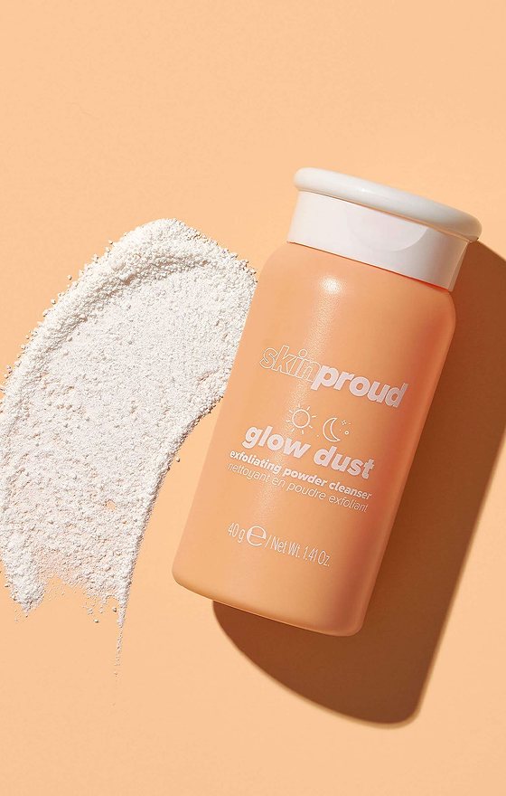 A bottle of powder cleanser beside a swipe of white powder.