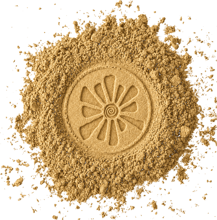 A mound of pale ochre multani mati powder with a sun motif pressed into its centre.